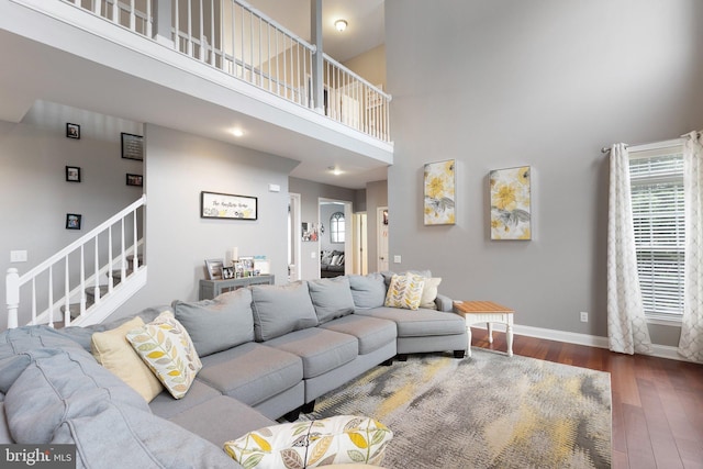 124 Willow Grove Mill Dr, Middletown, DE 19709 - living area featuring wood finished floors, stairway, a high ceiling, and baseboards