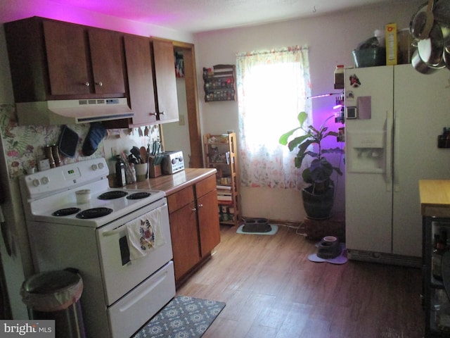 210 E Reynolds St, Cumberland, MD 21502 - kitchen with white appliances, under cabinet range hood, light wood finished floors, light countertops, and brown cabinets