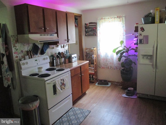210 E Reynolds St, Cumberland, MD 21502 - kitchen with white appliances, ventilation hood, light wood-type flooring, and brown cabinets