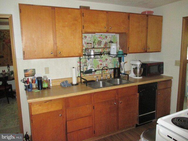 210 E Reynolds St, Cumberland, MD 21502 - kitchen featuring black appliances, a sink, light countertops, and brown cabinetry