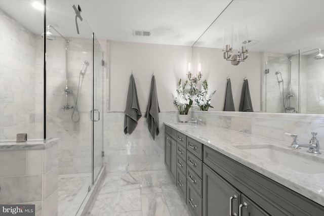 1775 Church St NW Unit 8, Washington, DC 20036 - full bath with marble finish floors, double vanity, a shower stall, a chandelier, and tile walls
