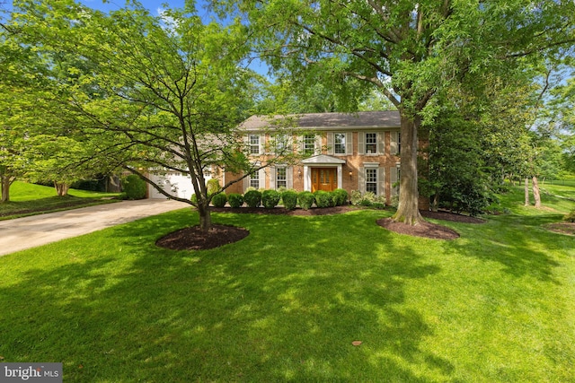 3713 Templeton Pl, Alexandria, VA 22304 - colonial house with concrete driveway, a front lawn, and brick siding