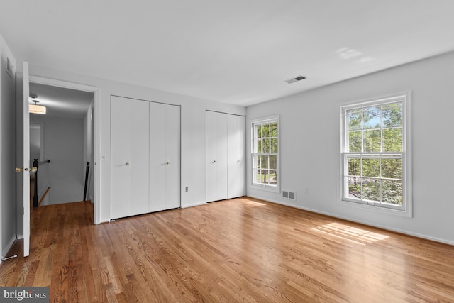 3713 Templeton Pl, Alexandria, VA 22304 - unfurnished bedroom featuring light wood-type flooring, two closets, and baseboards