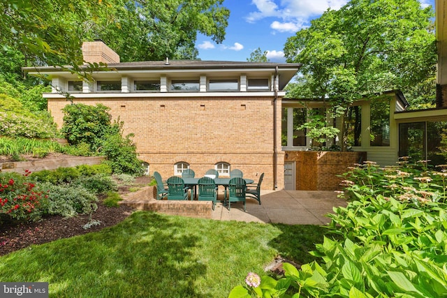 3713 Templeton Pl, Alexandria, VA 22304 - rear view of property with a chimney, brick siding, a patio area, and a yard