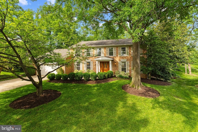 3713 Templeton Pl, Alexandria, VA 22304 - colonial-style house with brick siding, a front lawn, a garage, and concrete driveway