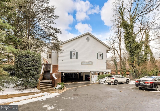 2050 N Calvert St Unit 106, Arlington, VA 22201 - view of property exterior with uncovered parking and a carport