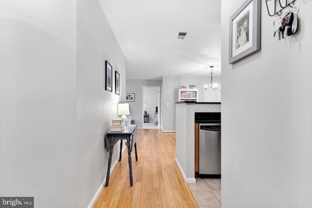 2050 N Calvert St Unit 106, Arlington, VA 22201 - hall featuring light wood finished floors and a chandelier