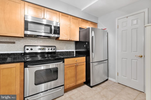 2050 N Calvert St Unit 106, Arlington, VA 22201 - kitchen with stainless steel appliances, tasteful backsplash, light tile patterned flooring, and dark stone counters