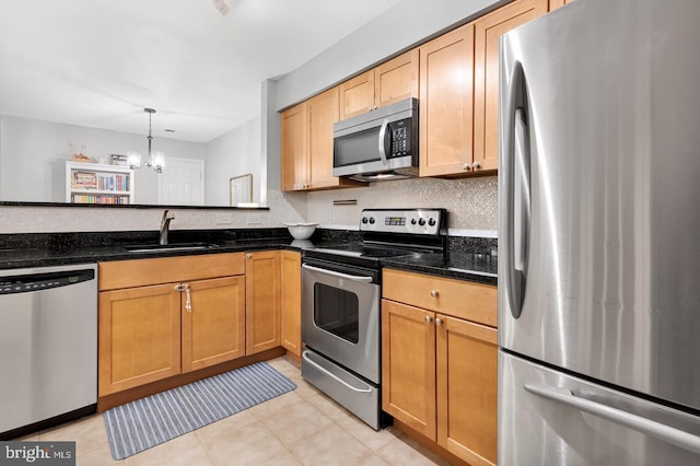2050 N Calvert St Unit 106, Arlington, VA 22201 - kitchen with stainless steel appliances, a chandelier, dark stone countertops, and pendant lighting