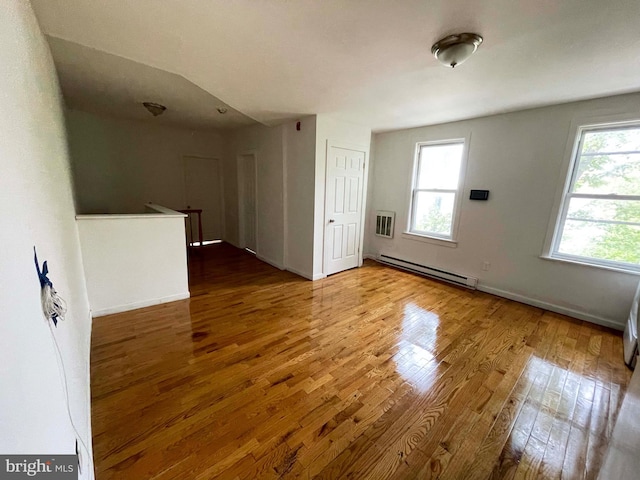 3647 N 19th St, Philadelphia, PA 19140 - unfurnished room featuring a baseboard radiator, wood finished floors, and baseboards