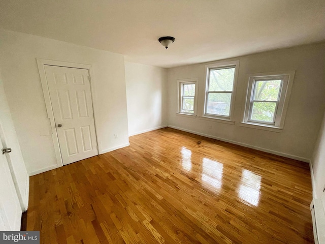 3647 N 19th St, Philadelphia, PA 19140 - spare room with healthy amount of natural light, wood finished floors, and baseboards