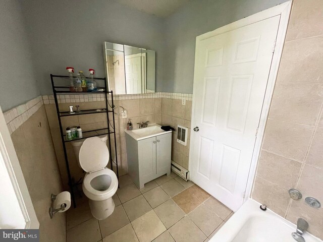 3647 N 19th St, Philadelphia, PA 19140 - full bathroom featuring tile walls, a baseboard radiator, vanity, toilet, and tile patterned floors