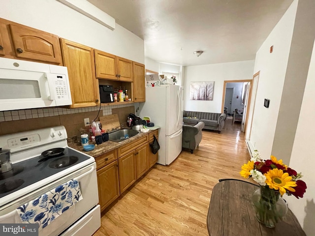 3647 N 19th St, Philadelphia, PA 19140 - kitchen with white appliances, light wood-style floors, backsplash, brown cabinetry, and a sink