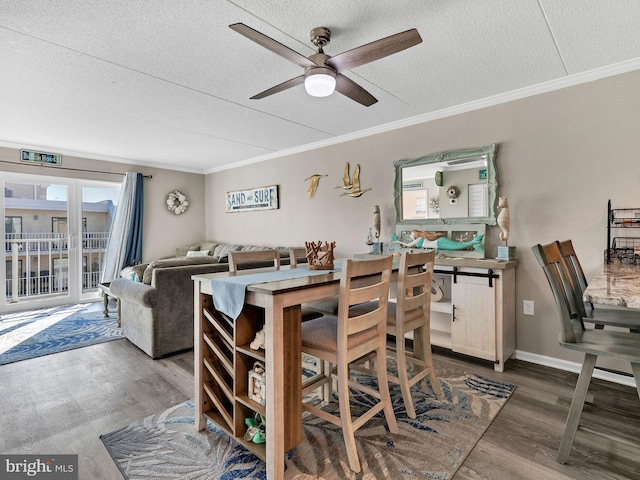 4711 Coastal Hwy Unit 538, Ocean City, MD 21842 - dining space with a textured ceiling, a ceiling fan, crown molding, and wood finished floors
