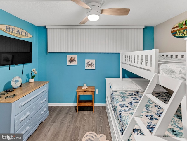 4711 Coastal Hwy Unit 538, Ocean City, MD 21842 - bedroom featuring wood finished floors, a ceiling fan, and baseboards