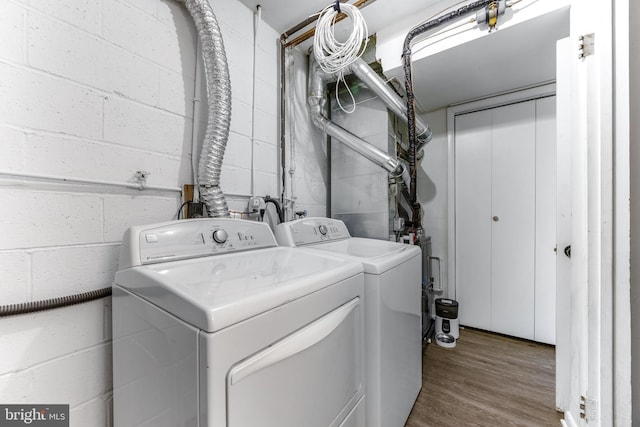 1302 Burlington Dr, Odenton, MD 21113 - laundry area with washer and clothes dryer, concrete block wall, and wood finished floors