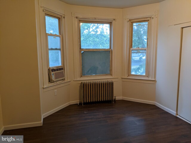 4303 N Franklin St, Philadelphia, PA 19140 - unfurnished room featuring radiator heating unit, dark wood-style flooring, cooling unit, baseboards, and plenty of natural light