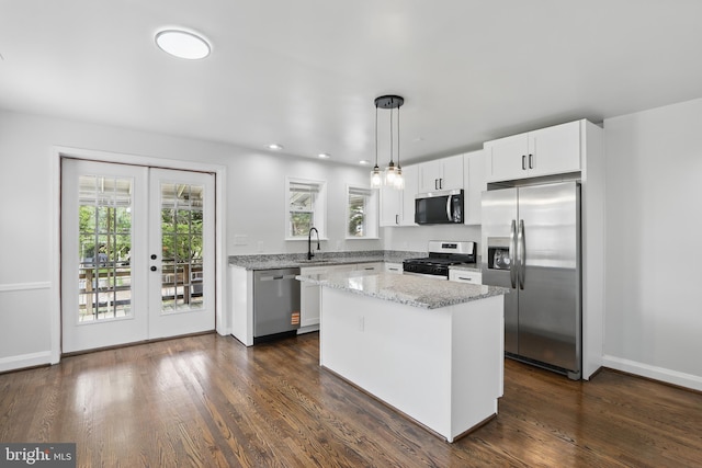 234 Linden Ave, Towson, MD 21286 - kitchen with appliances with stainless steel finishes, french doors, white cabinetry, light stone counters, and a kitchen island