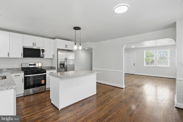 234 Linden Ave, Towson, MD 21286 - kitchen featuring stainless steel appliances, arched walkways, a kitchen island, dark wood-style flooring, and white cabinetry