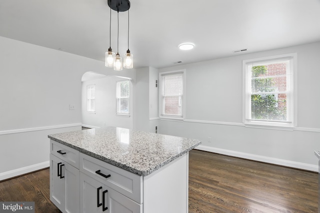 234 Linden Ave, Towson, MD 21286 - kitchen with pendant lighting, light stone countertops, dark wood finished floors, white cabinetry, and baseboards