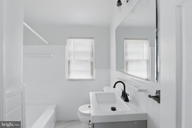 234 Linden Ave, Towson, MD 21286 - bathroom with tile walls, toilet, vanity, marble finish flooring, and a wainscoted wall