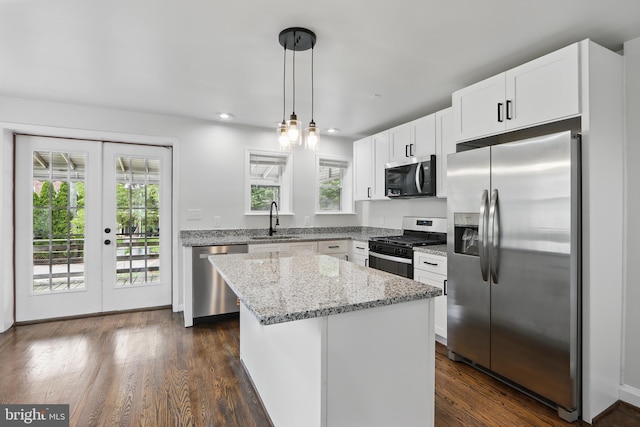 234 Linden Ave, Towson, MD 21286 - kitchen with stainless steel appliances, a sink, light stone counters, a kitchen island, and white cabinetry