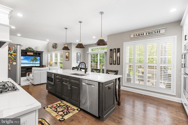 48 Avalon Ct Unit 2301, Doylestown, PA 18901 - kitchen with appliances with stainless steel finishes, a sink, open floor plan, dark wood finished floors, and an island with sink