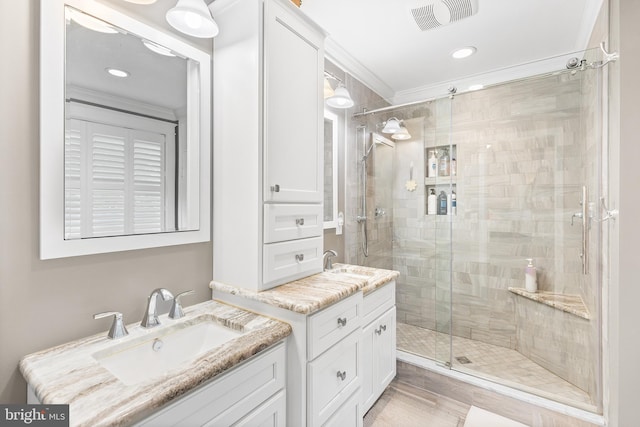 48 Avalon Ct Unit 2301, Doylestown, PA 18901 - bathroom with a shower stall, two vanities, crown molding, and recessed lighting