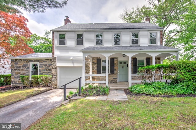 515 Devon Rd, Havertown, PA 19083 - view of front facade with a porch, a chimney, driveway, and a garage