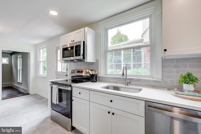 515 Devon Rd, Havertown, PA 19083 - kitchen with stainless steel appliances, a sink, light countertops, white cabinets, and recessed lighting