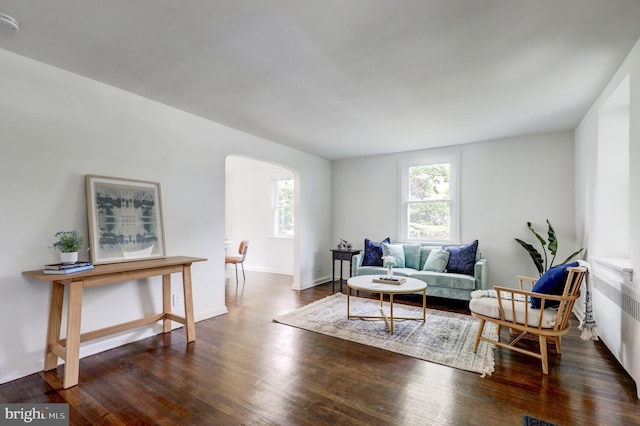 515 Devon Rd, Havertown, PA 19083 - living room featuring arched walkways, wood finished floors, and baseboards