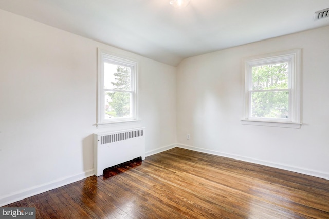 515 Devon Rd, Havertown, PA 19083 - unfurnished room with radiator heating unit, dark wood-style floors, plenty of natural light, baseboards, and vaulted ceiling
