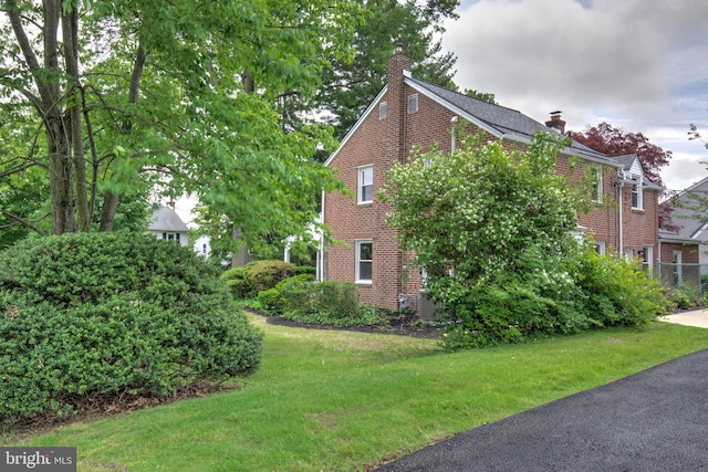 515 Devon Rd, Havertown, PA 19083 - view of side of property featuring brick siding, a chimney, and a lawn