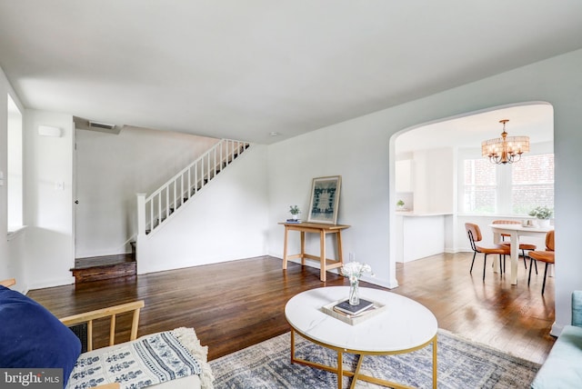 515 Devon Rd, Havertown, PA 19083 - living area with wood finished floors, a chandelier, stairs, and arched walkways