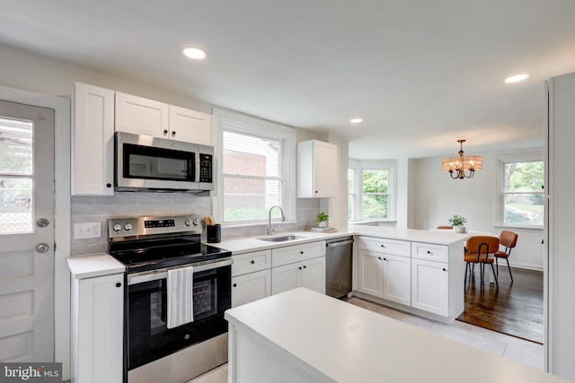 515 Devon Rd, Havertown, PA 19083 - kitchen with appliances with stainless steel finishes, a sink, a peninsula, plenty of natural light, and recessed lighting