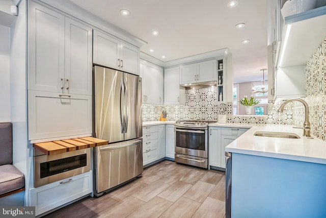 510 Pine St, Philadelphia, PA 19106 - kitchen featuring appliances with stainless steel finishes, a sink, decorative backsplash, light countertops, and recessed lighting