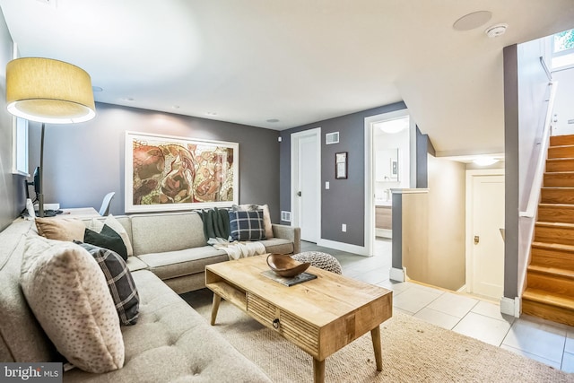 510 Pine St, Philadelphia, PA 19106 - living room with stairway, light tile patterned floors, and baseboards