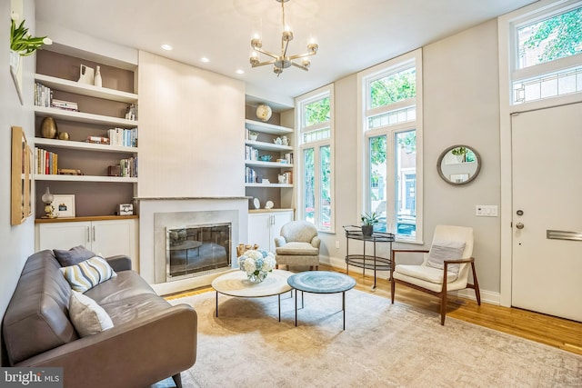 510 Pine St, Philadelphia, PA 19106 - living area with light wood finished floors, baseboards, a glass covered fireplace, a chandelier, and recessed lighting