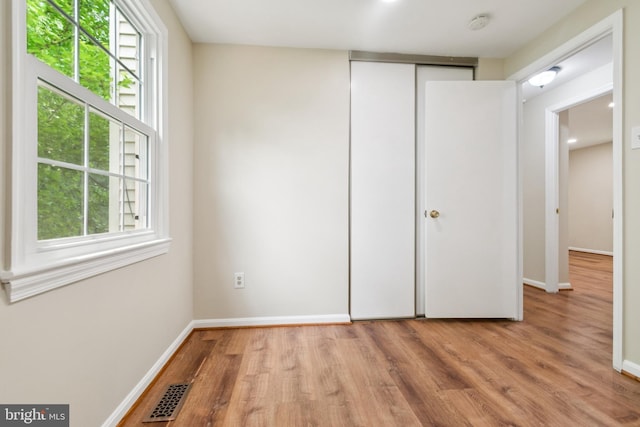 122 Sharpstead Ln, Gaithersburg, MD 20878 - unfurnished bedroom with light wood-style flooring, baseboards, and multiple windows
