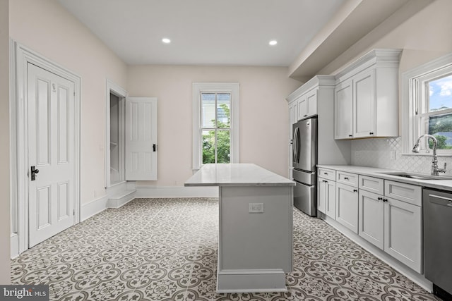 3 E Poplar St, Wenonah, NJ 08090 - kitchen featuring appliances with stainless steel finishes, a sink, plenty of natural light, a kitchen island, and recessed lighting