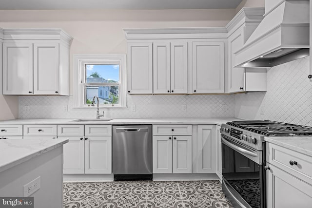 3 E Poplar St, Wenonah, NJ 08090 - kitchen featuring stainless steel appliances, custom range hood, a sink, white cabinets, and light stone counters