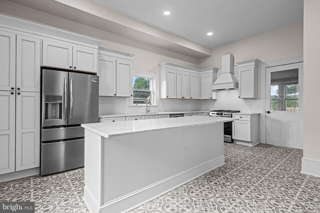 3 E Poplar St, Wenonah, NJ 08090 - kitchen featuring premium range hood, appliances with stainless steel finishes, healthy amount of natural light, a kitchen island, and recessed lighting