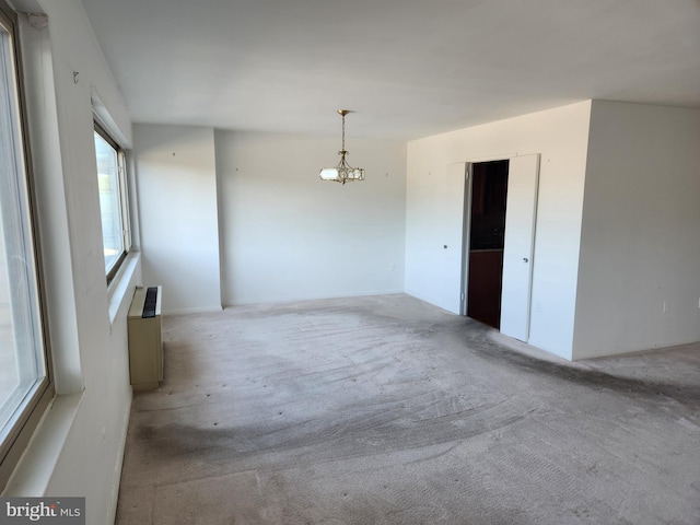 7121 Park Heights Ave Unit 206, Baltimore, MD 21215 - spare room featuring carpet and a chandelier