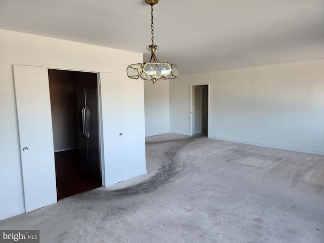 7121 Park Heights Ave Unit 206, Baltimore, MD 21215 - spare room with light carpet and a chandelier