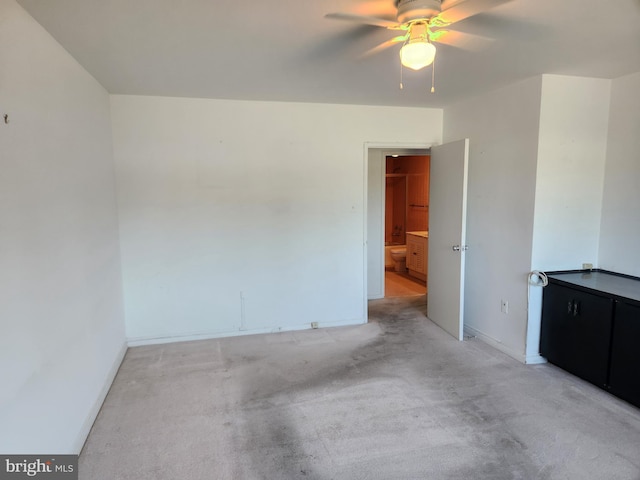 7121 Park Heights Ave Unit 206, Baltimore, MD 21215 - empty room featuring a ceiling fan, baseboards, and light carpet