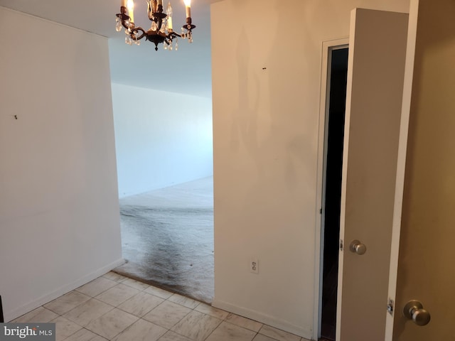 7121 Park Heights Ave Unit 206, Baltimore, MD 21215 - hall featuring light colored carpet, a chandelier, and light tile patterned floors