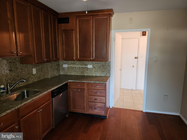 7121 Park Heights Ave Unit 206, Baltimore, MD 21215 - kitchen with dishwasher, a sink, tasteful backsplash, dark wood finished floors, and baseboards