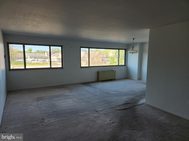 7121 Park Heights Ave Unit 206, Baltimore, MD 21215 - carpeted empty room with a chandelier