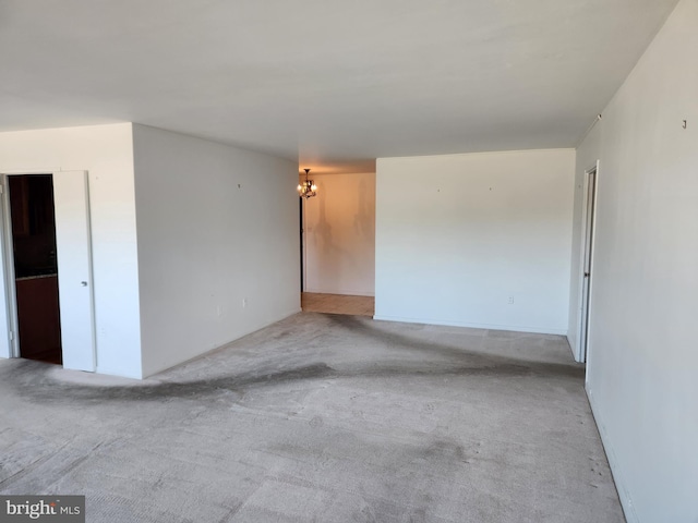 7121 Park Heights Ave Unit 206, Baltimore, MD 21215 - unfurnished room featuring a chandelier and carpet flooring