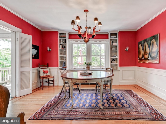 326 Saint Dunstans Rd, Baltimore, MD 21212 - dining room featuring a chandelier, wood finished floors, built in features, wainscoting, and crown molding